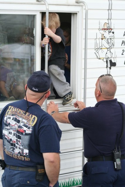 Chuck Flinn and Chuck Ray assist with exiting the Fire Safety trailer